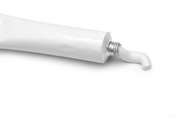 Isolated white tube of paint, paint squeezed out stock photo
