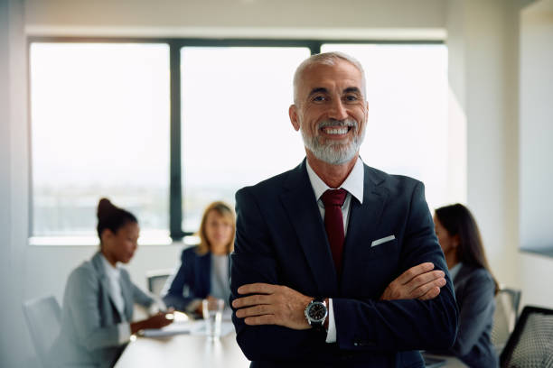 istock Confident mature CEO with crossed arms in the office looking at camera. 1840866290