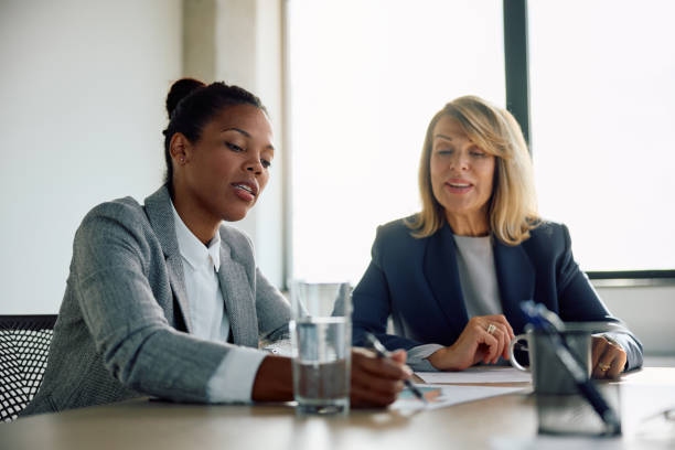 istock Two businesswomen cooperating while analyzing on reports in the office. 1840867318