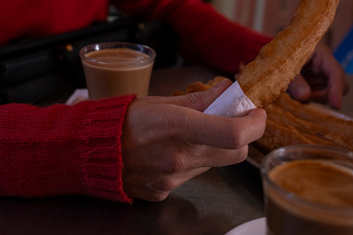Flavors of Malaga churros in the hands of a woman, Morning Tradition