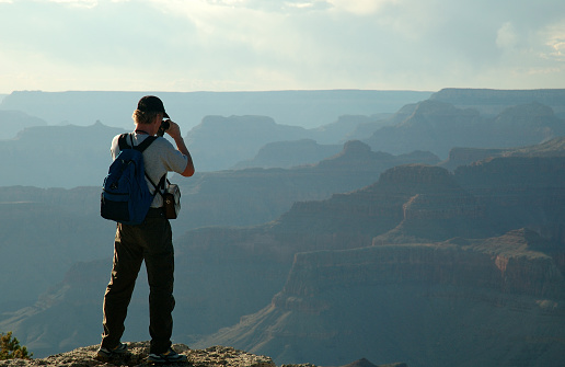 A man stands at the Grand Canyon and looks into the distance. He is looking for the future. For some answers. For something what you want.