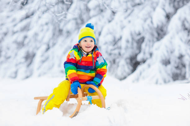 istock Boy on sled ride. Child sledding. Kid on sledge 1840877347