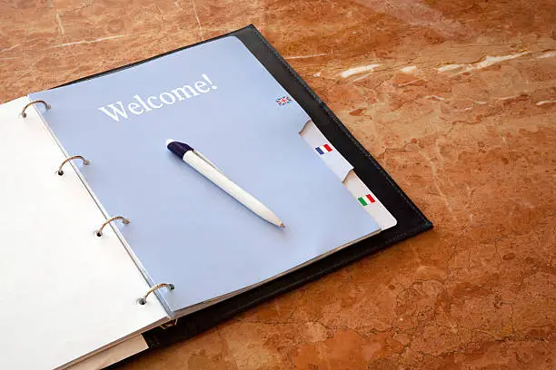 "Hotel guestbook with english, french and italian dividers, open at the Welcome page."