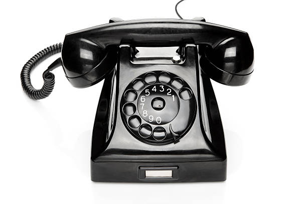 istock An old black rotary telephone on a white background 184088728