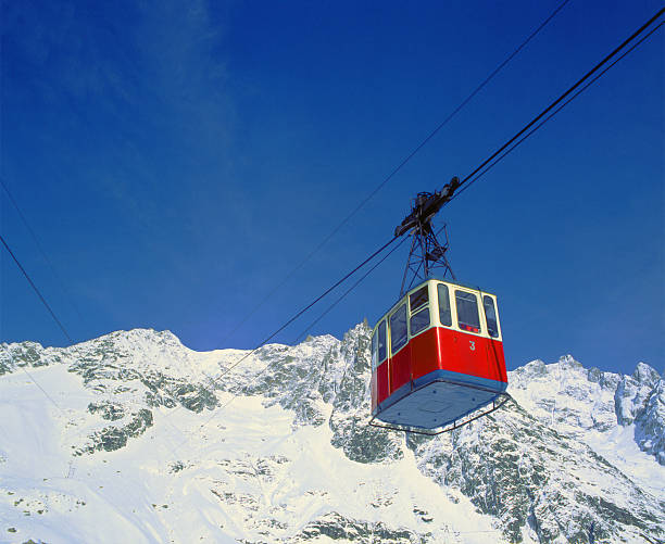 Old red cableway, snowy mountains and blue sky on background  ski lift photos stock pictures, royalty-free photos & images