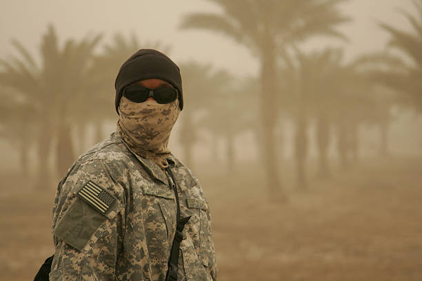 Soldier in Sandstorm "A masked American soldier withstands a sandstorm in Baghdad, Iraq." military deployment photos stock pictures, royalty-free photos & images