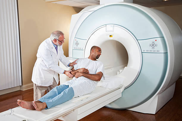 istock Doctor talking to patient getting MRI scan 184089423