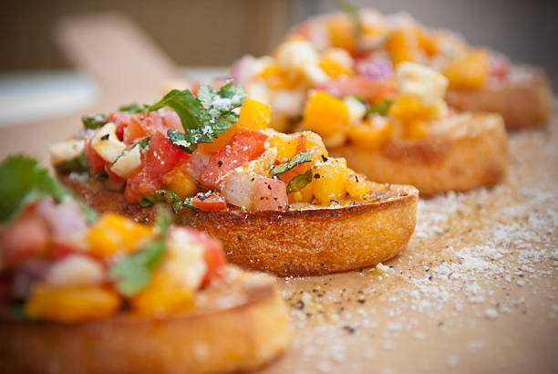 Salsa Bruschetta Selective-focus image of Bruschetta with colorful salsa/chutney bruschetta stock pictures, royalty-free photos & images