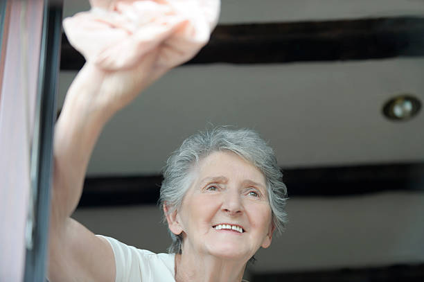 istock Senior woman washing window 184090184