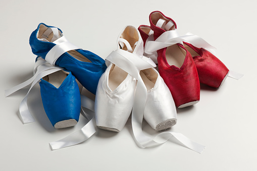 Blue, white and red, US flag colors  pointe shoes on a white background.