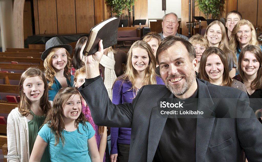 Pastor holding Bibel mit den Menschen, die hinter - Lizenzfrei Gemeinde Stock-Foto