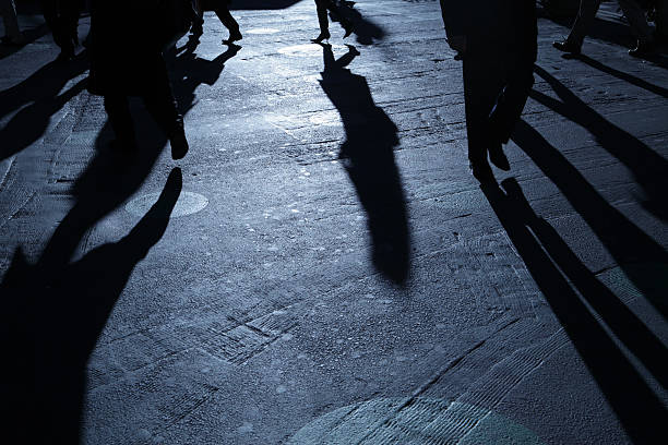 istock People walking in ominous blue night shadows 184090662
