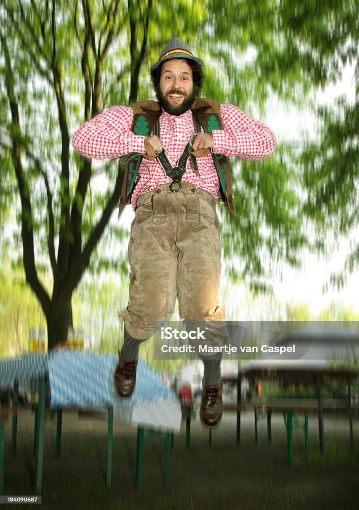 Bavarian Jumping Guy in a Beergarden Bavarian Bearded Jumping Guy in a Biergarten.  Activity Stock Photo