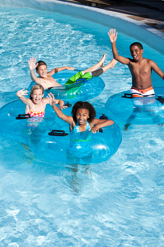 Children, ages 8 to 13, having fun on lazy river at water park