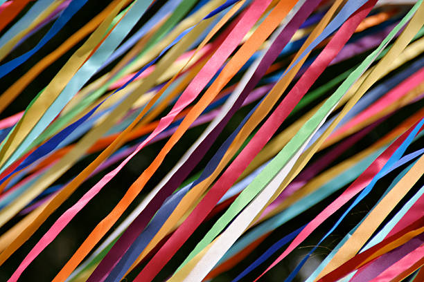 Flying Color Streamers—Carnival Ribbons for Graduations, Parties, Social Events Subject: A wall of festive and colorful streamers flying in the air celerbrating special occasions ribbon flow stock pictures, royalty-free photos & images