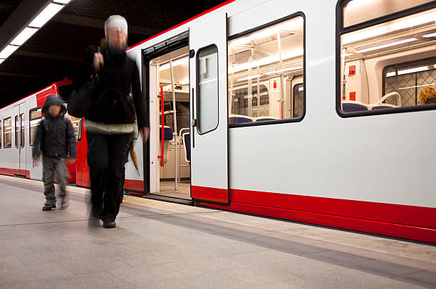 istock Mother with Son Getting off the Subway, Blurred Motion 184091317