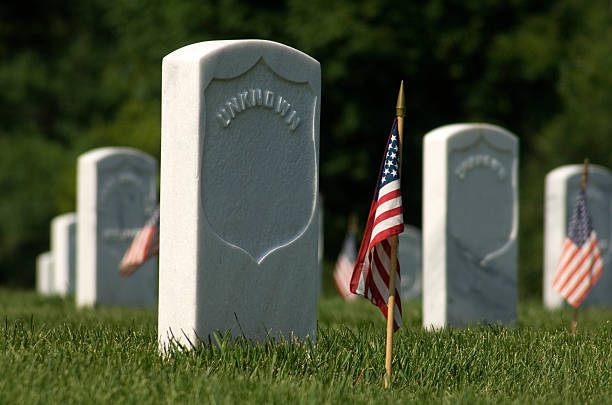 istock Unknown Tombstone Military Cemetary American Flag Gound Level 184091385