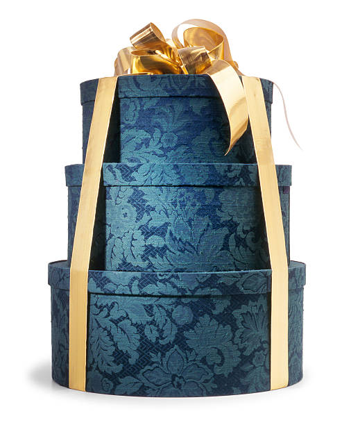 Hat boxes stacked Hat boxes stacked with gold ribbon tied around them. stacked hat boxes stock pictures, royalty-free photos & images
