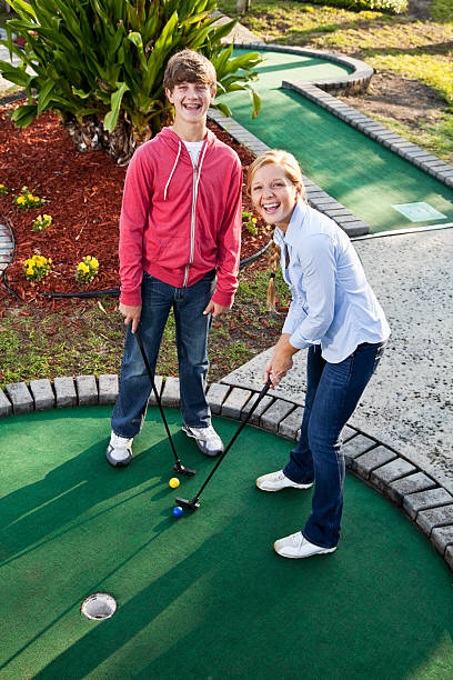 istock Teenage couple playing miniature golf 184091669