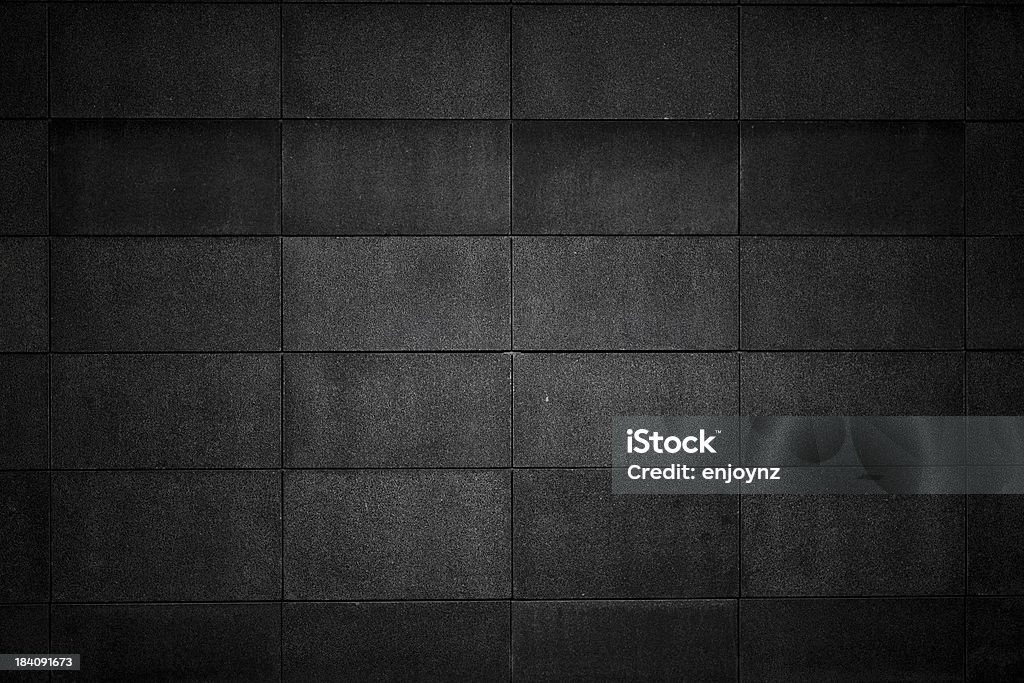 Concrete block wall Dark concrete block background. Black Color Stock Photo