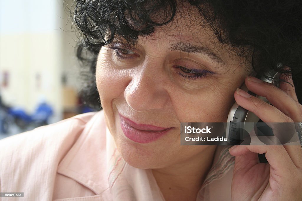 Elderly female talking on her mobile phone beautiful middle aged woman talking on mobile 50-59 Years Stock Photo