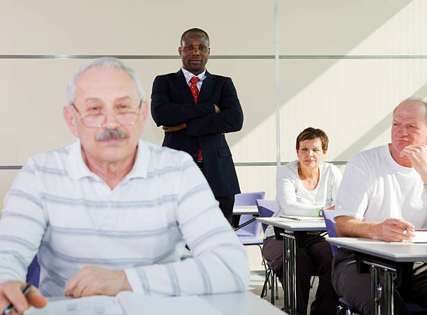 istock Senior students in education room...black teacher watching 184091909