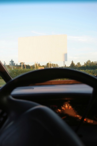 Drive-in with big screen with the interior car view.