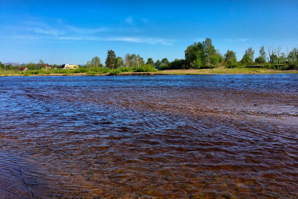 istock summer landscape with river and blue sky. 1840929608