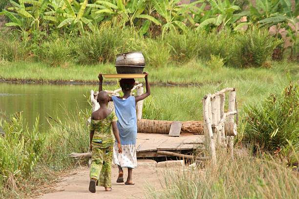 kids crossing lagoon ouidah, benin benin stock pictures, royalty-free photos & images