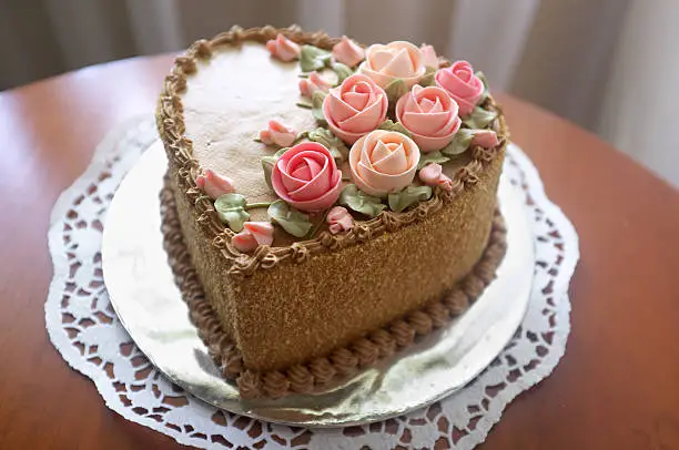 beautiful heart shaped cake decorated with buttercream