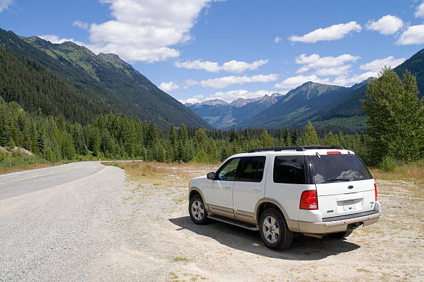 Mountain road "Parked 4WD next to mountain road in Alberta, Canada.Please also see :" sports utility vehicle stock pictures, royalty-free photos & images