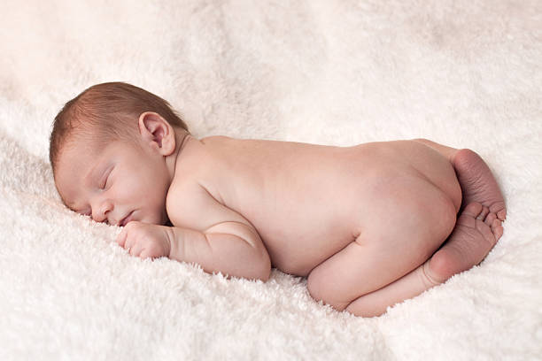 istock Newborn Baby on White Fur 184094229