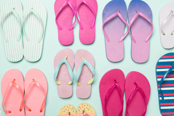 istock Many bright flip flops on color background, top view 1840945618