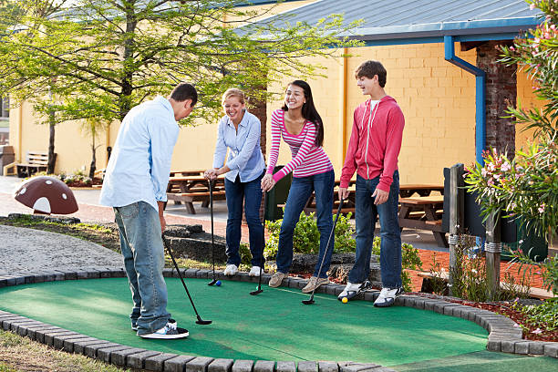 istock Teenagers playing miniature golf 184094935