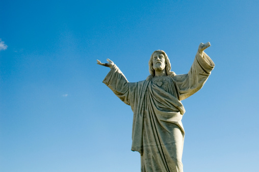 Jesus with hands towards the sky statue