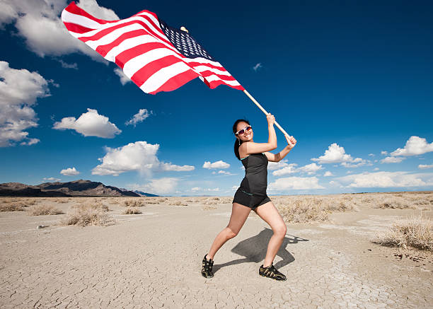 istock Hispanic Athlete Waving American Flag in the Desert 184095533