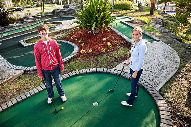 istock Teenage couple playing miniature golf 184095671