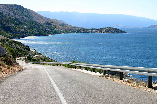 istock Asphalt road to drive on while admiring the scenic ocean 184095808