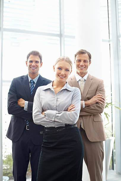 istock Team of three business people standing with arms folded 184095873