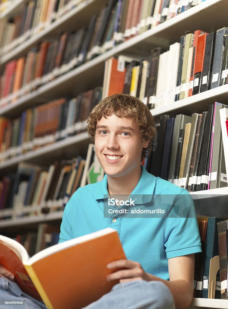 Caucasian student reading a book Caucasian student reading a book in the library 20-29 Years Stock Photo