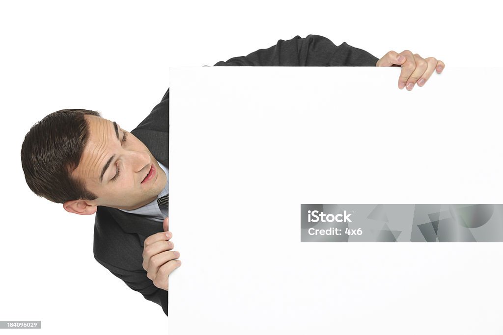 Businessman holding placard Businessman holding placardhttp://www.twodozendesign.info/i/1.png 20-29 Years Stock Photo