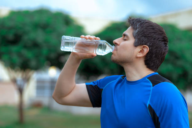 istock Man drinking water from plastic bottle and doing sports with copy space 1840963196
