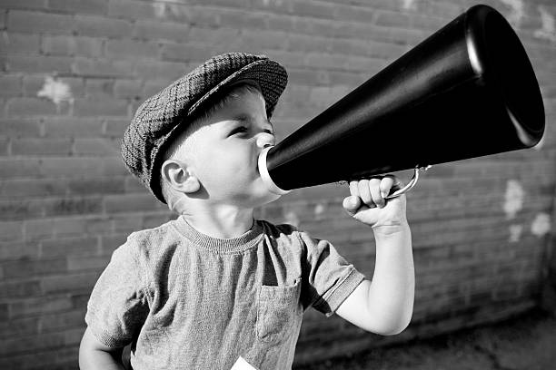 Attention! (b&w) Items for sale! Words to be heard! A young salesman or director makes his ideas known. Look below for the color version. public speaker photos stock pictures, royalty-free photos & images