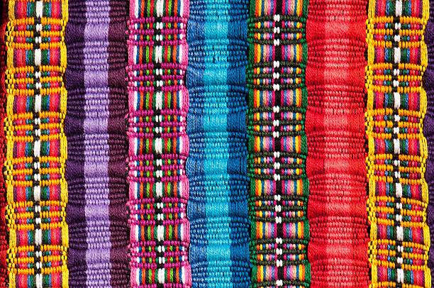 Cropped section of a Mexican blanket in bright colours Brightly Colored Woven Material woven fabric stock pictures, royalty-free photos & images