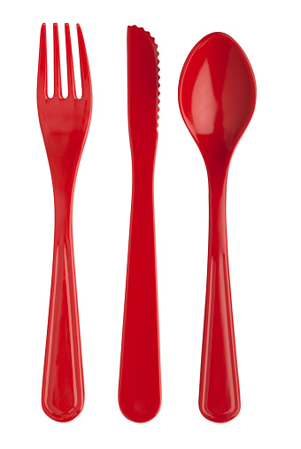 A studio shot of a red plastic knife fork and spoon isolated on a white background with separate clipping paths