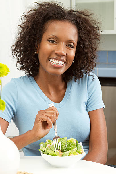 istock Woman eating a salad 184097221