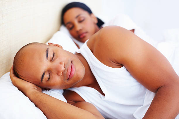 istock Relaxed young man in bed with woman 184097303