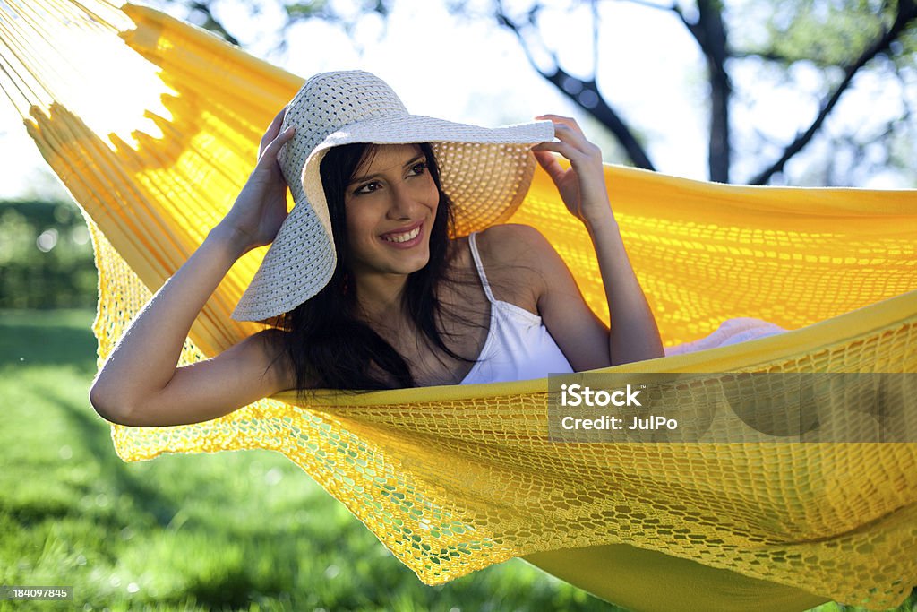 Summer "Young woman sitting in hammock in summer park, shallow DOF" Adult Stock Photo