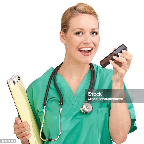 Medical Nurse Dictating Into A Smart Phone Stock Photo - Download Image Now - Dictation, Healthcare And Medicine, 25-29 Years