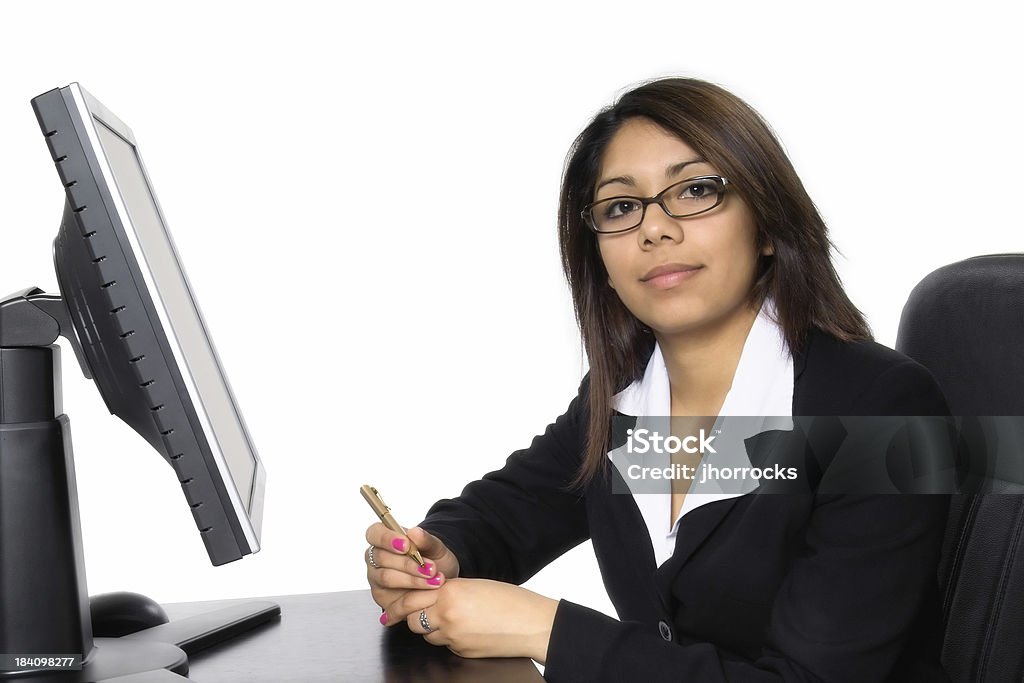 Businesswoman At Desk Attentive young businesswoman. Trainee Stock Photo